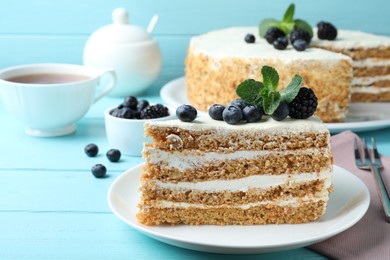 Delicious cake with blueberries on light blue wooden table, closeup