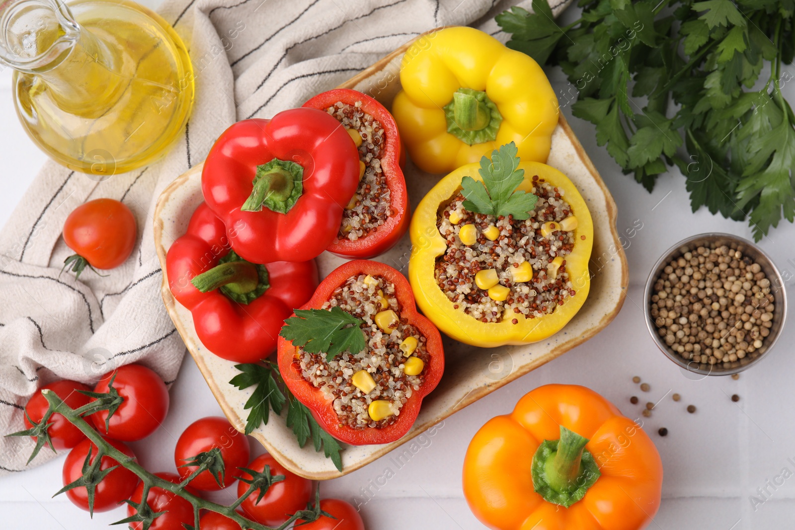 Photo of Flat lay composition with quinoa stuffed bell peppers on white tiled table