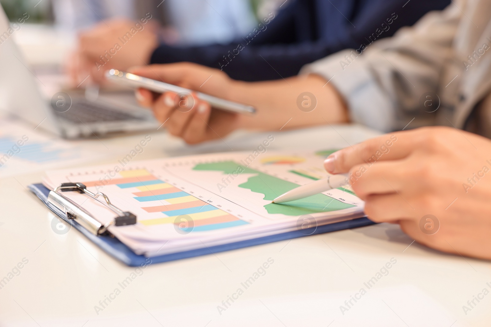 Photo of Employees working with charts at table, closeup. Startup project
