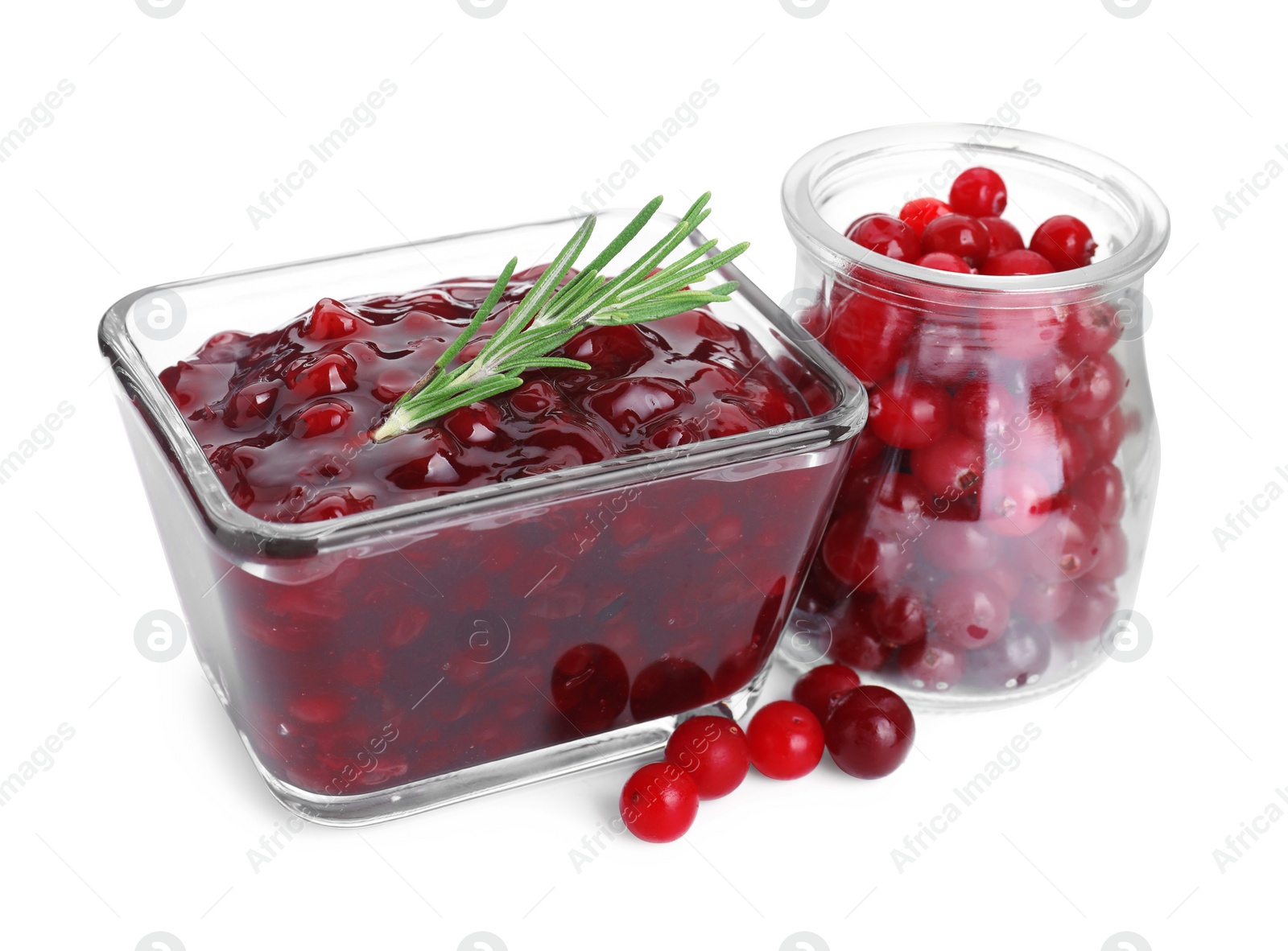 Photo of Tasty cranberry sauce in bowl and glass jar with fresh berries isolated on white
