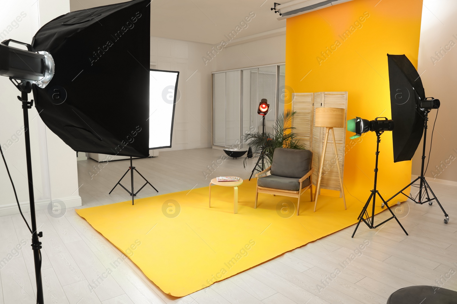 Photo of Stylish furniture in photo studio with professional equipment