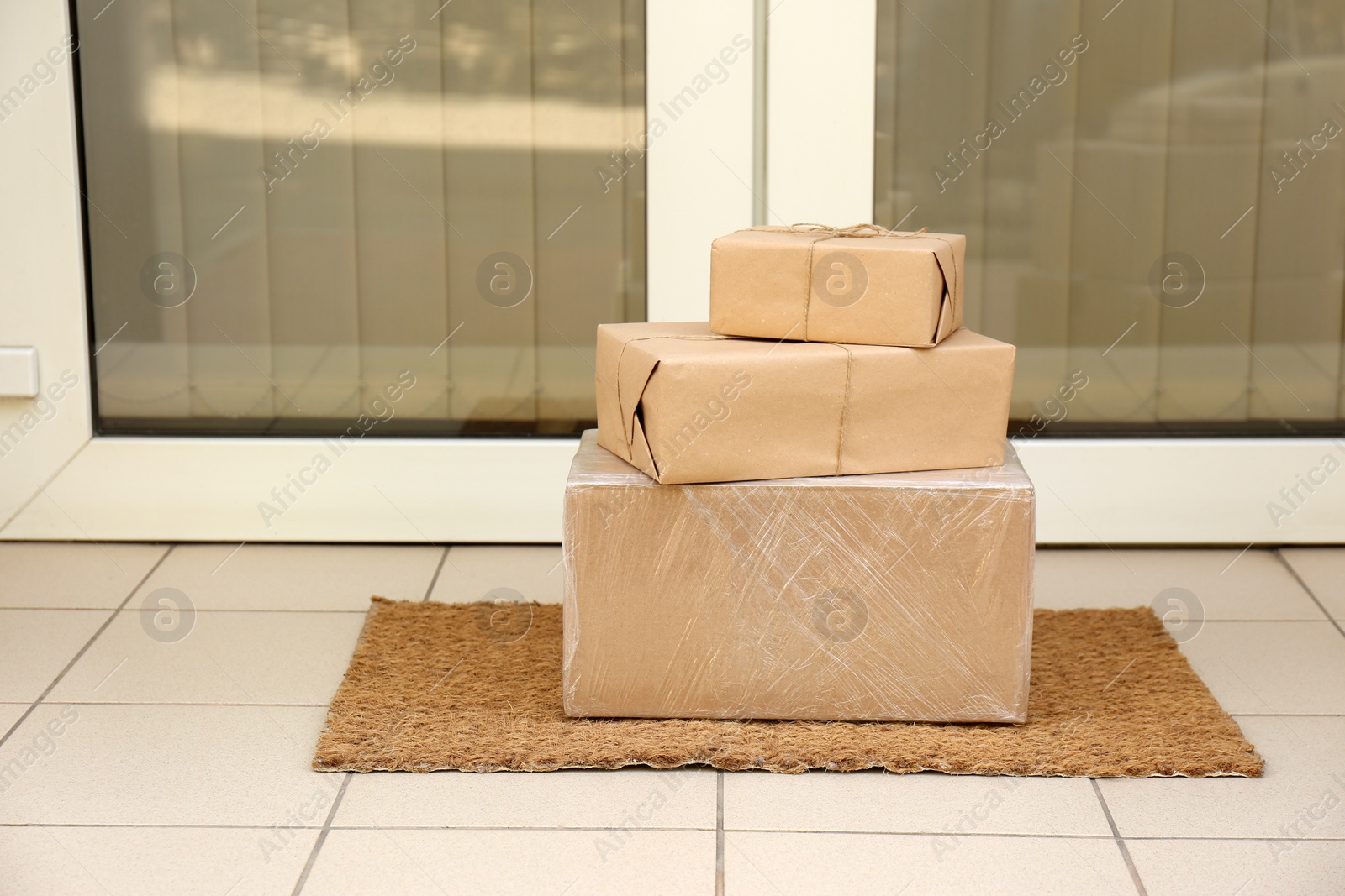 Photo of Delivered parcels on door mat near entrance