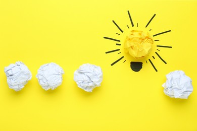 Photo of Creative flat lay composition with paper balls on yellow background. Idea concept