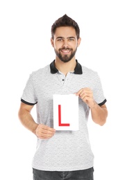 Photo of Young man with L-plate on white background. Getting driving license