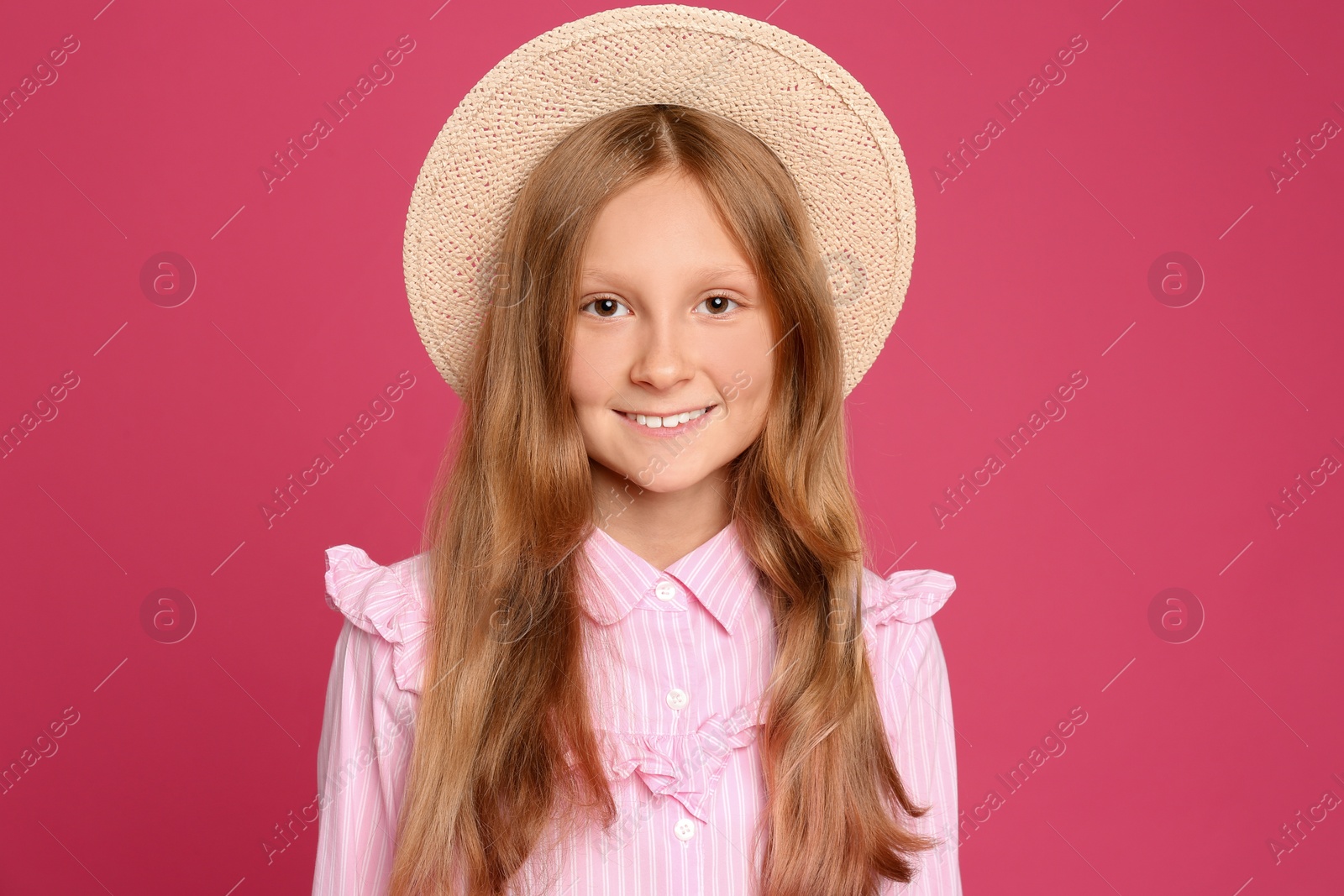 Photo of Portrait of preteen girl in hat on pink background