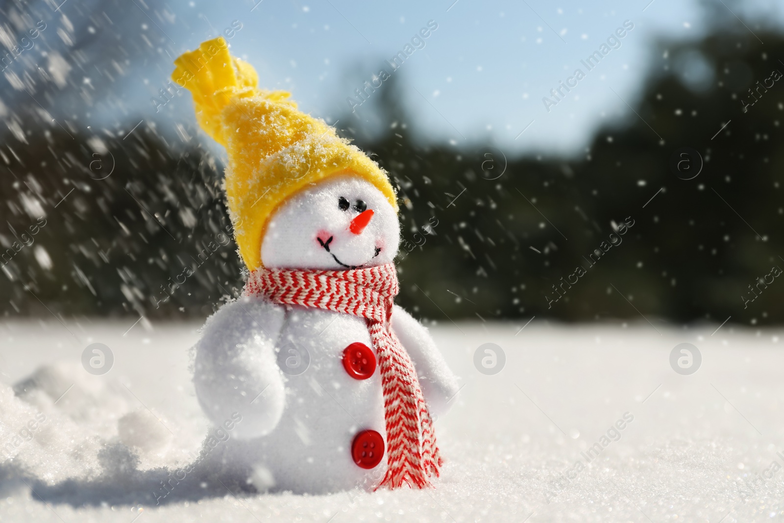 Photo of Cute small decorative snowman outdoors on winter day, space for text