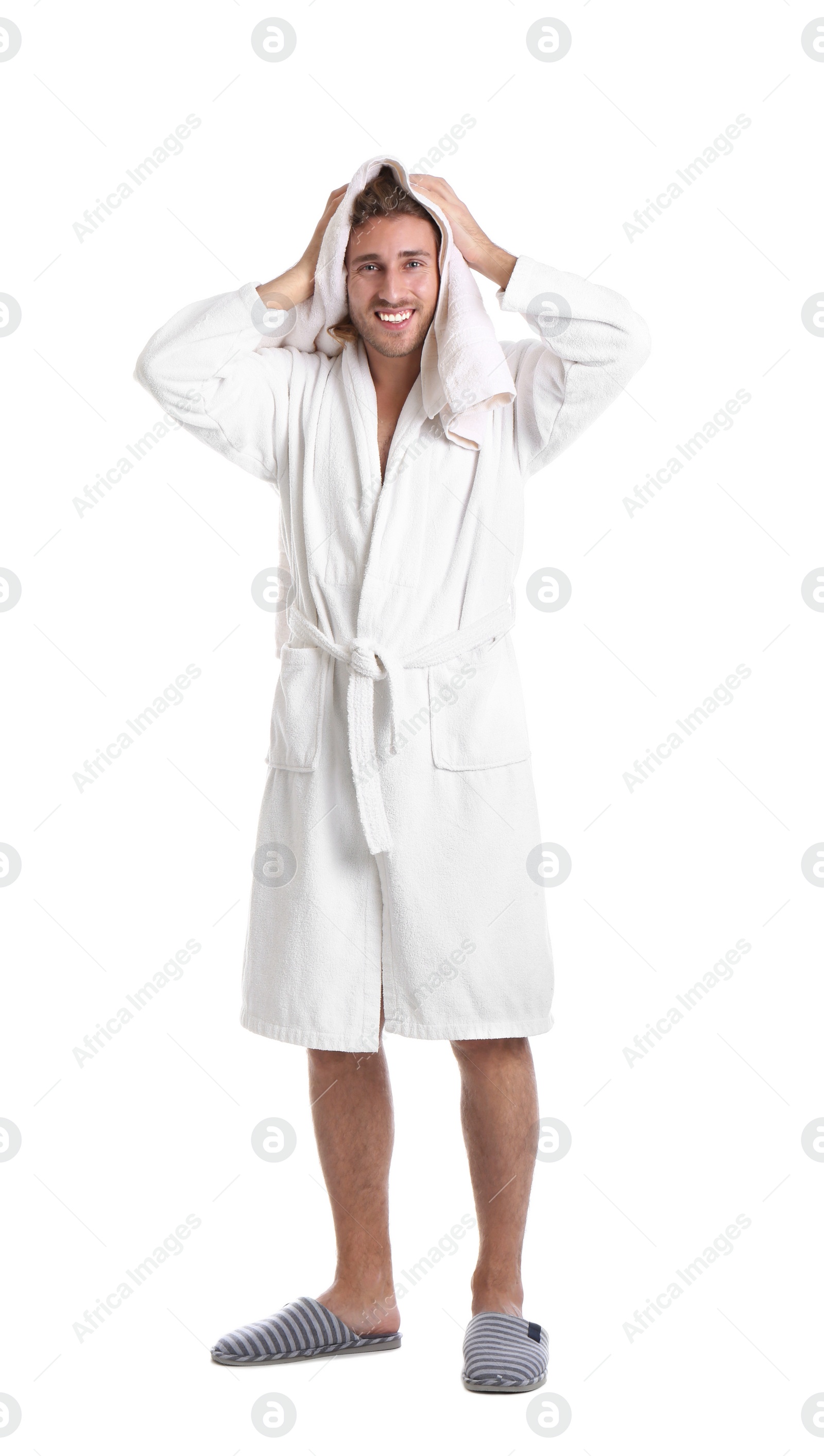 Photo of Young man in bathrobe drying hair with towel on white background