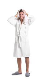 Photo of Young man in bathrobe drying hair with towel on white background
