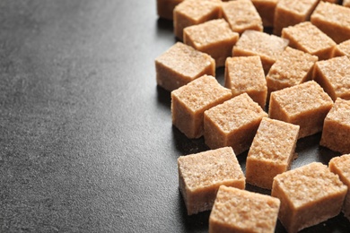 Photo of Cubes of brown sugar on table