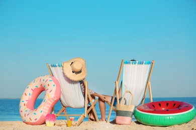 Photo of Young couple in beach chairs at seacoast