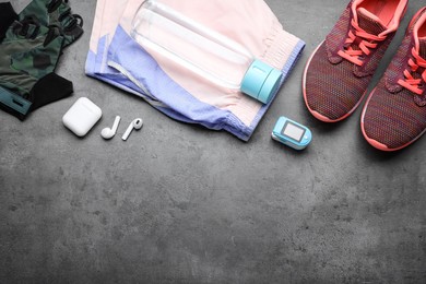 Photo of Flat lay composition with different cycling accessories on grey background, space for text