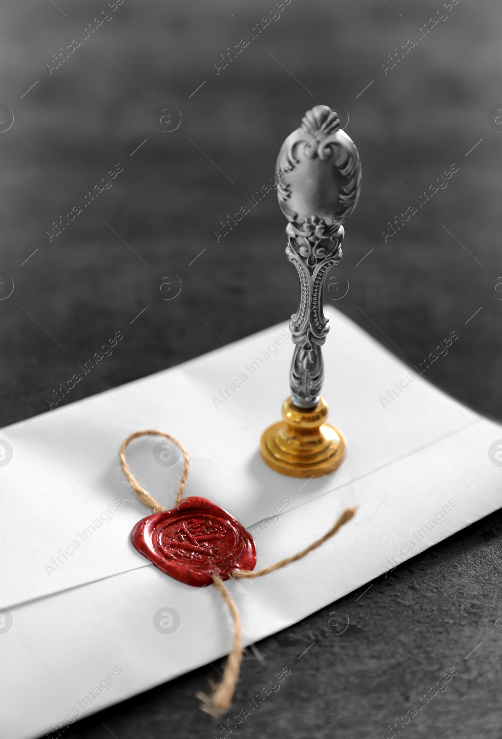 Photo of Vintage notary stamp and sealed document on grey background, closeup