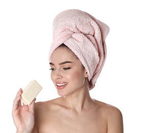 Young woman with soap bar on white background