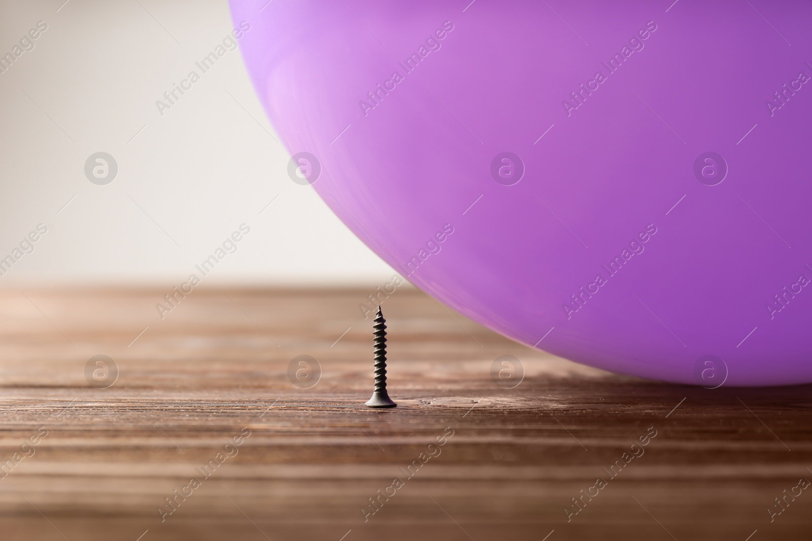 Photo of Color balloon and nail on table against white background, space for text
