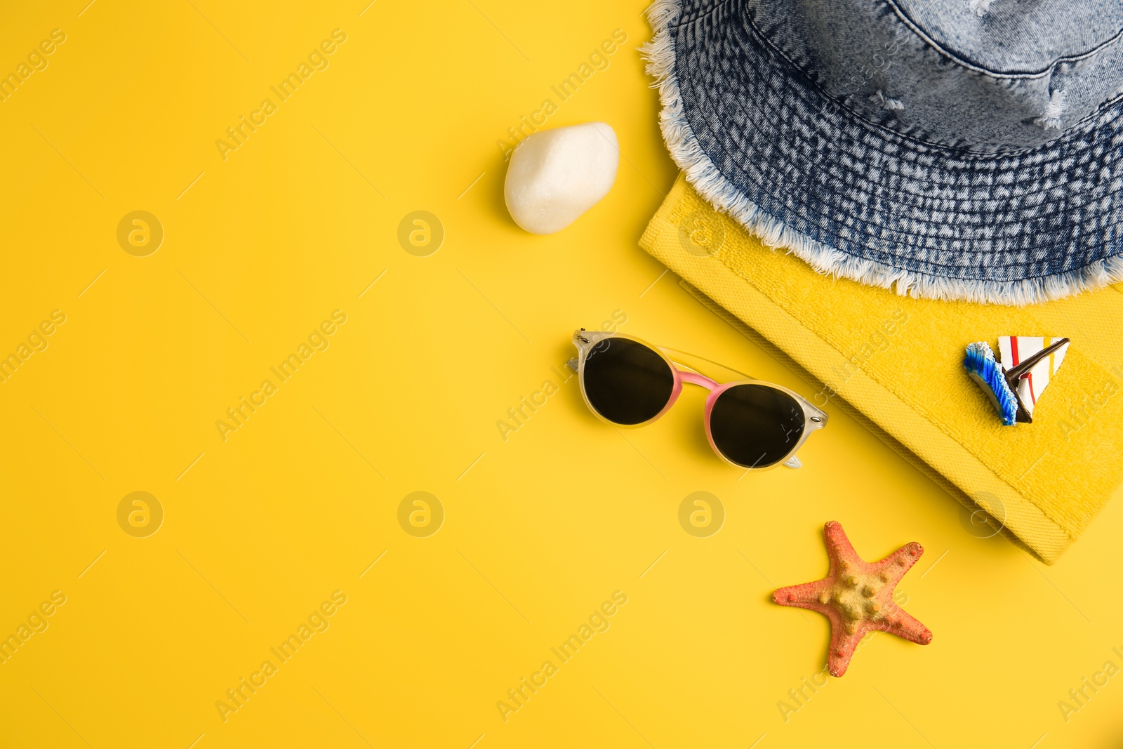 Photo of Flat lay composition with beach accessories on orange background, space for text