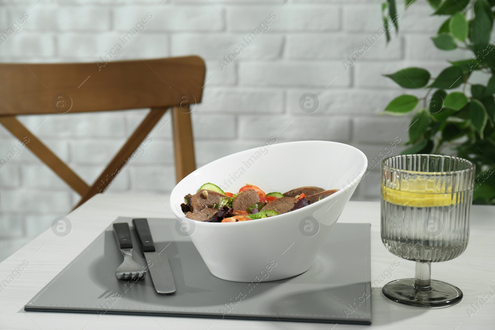 Photo of Delicious salad with beef tongue and vegetables served on white wooden table indoors. Space for text