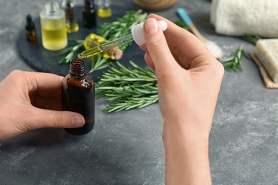 Photo of Woman with bottle of essential oil, closeup