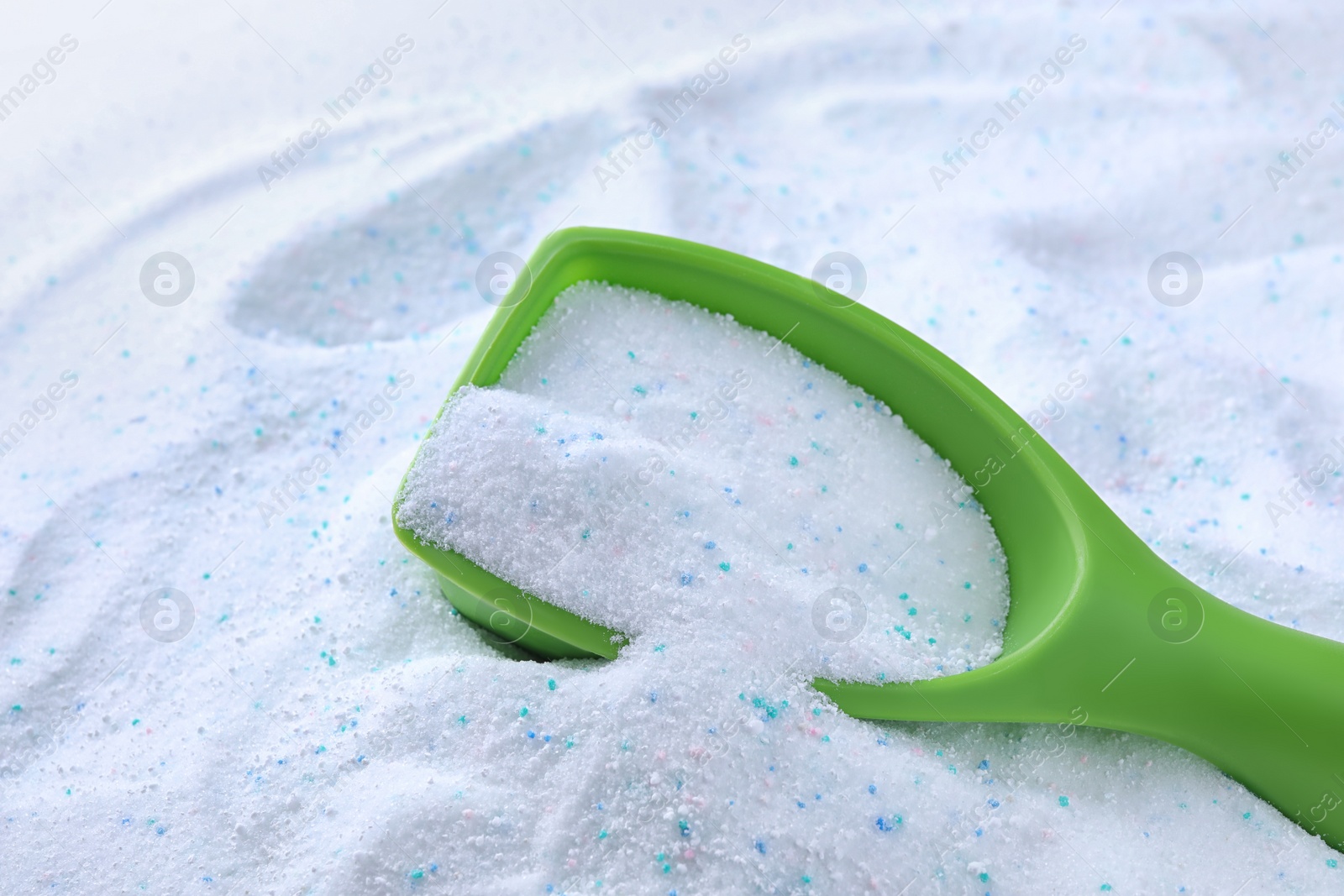 Photo of Measuring scoop with laundry powder, closeup view