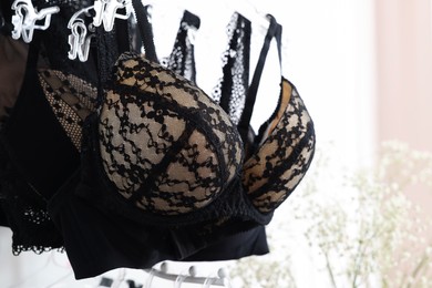 Luxury women's underwear on hangers in lingerie store, closeup