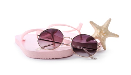 Photo of Flip flops, sunglasses and starfish on white background. Beach objects