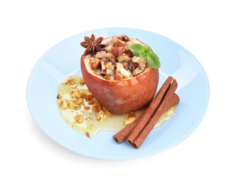 Tasty baked apple with nuts, honey, spices and mint isolated on white