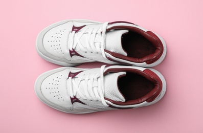 Photo of Pair of stylish shoes on pink background, top view