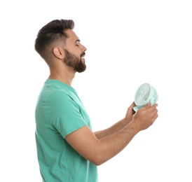 Man enjoying air flow from portable fan on white background. Summer heat