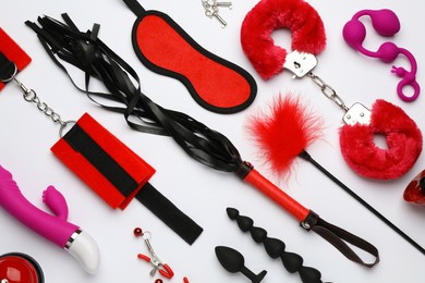 Sex toys and accessories on white background, flat lay