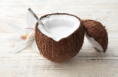 Nut with fresh coconut milk on wooden background