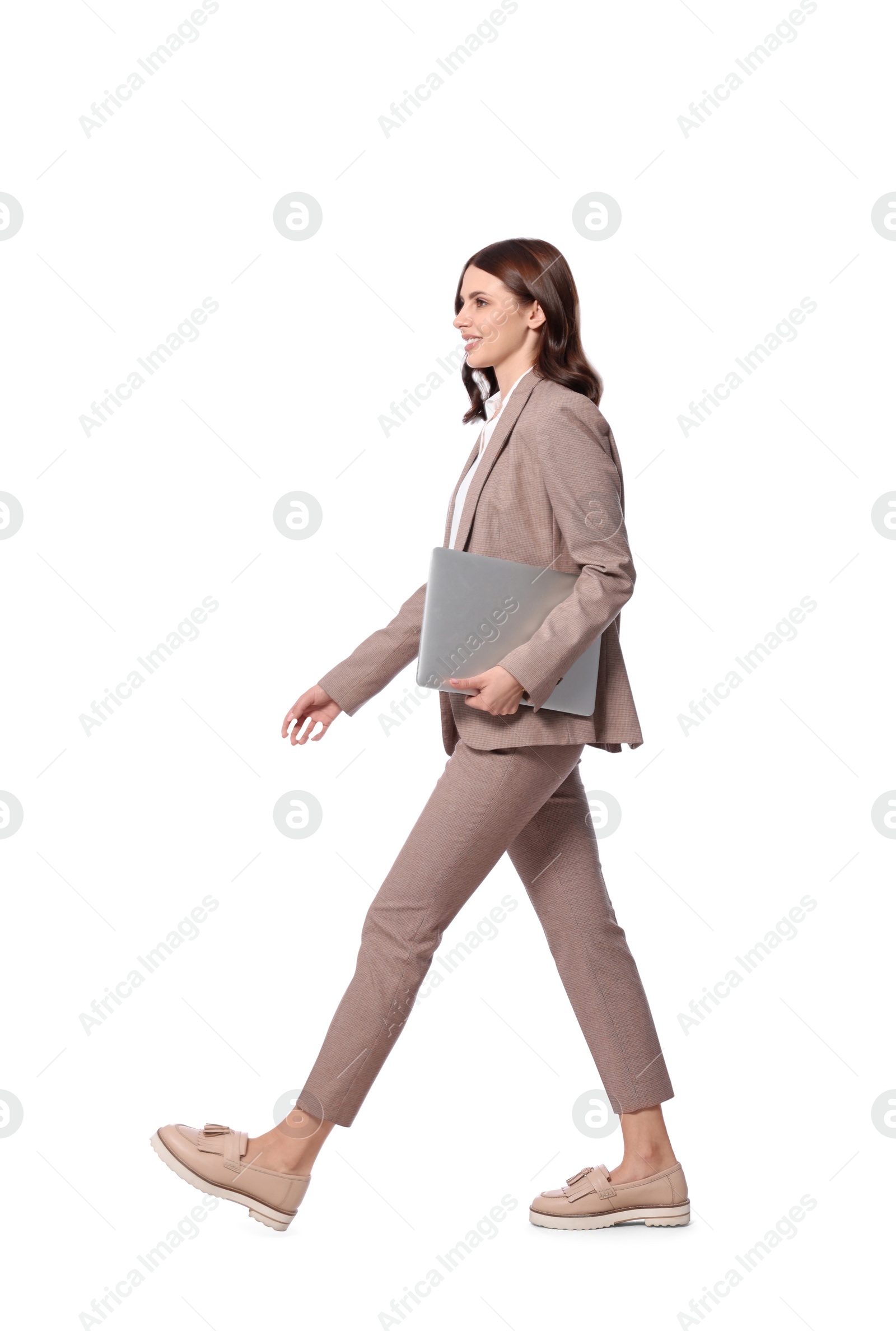 Photo of Happy young businesswoman with laptop walking on white background