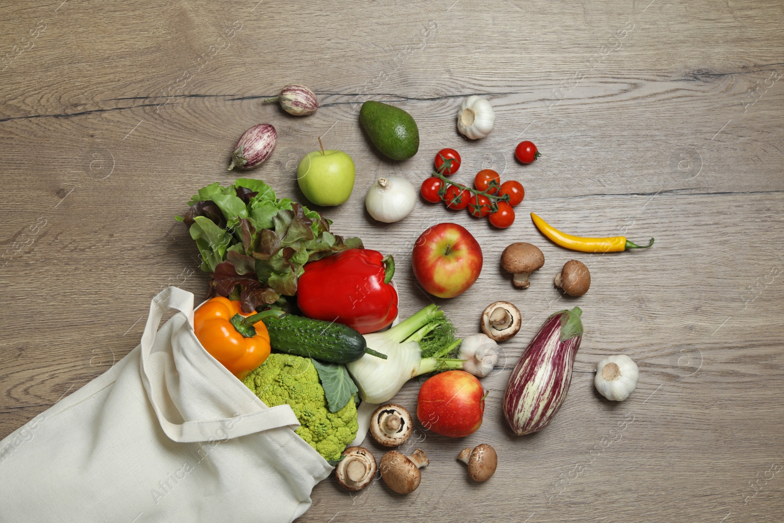 Photo of Bag with fresh vegetables and fruits on wooden background, flat lay