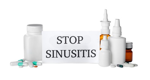Photo of Card with phrase STOP SINUSITIS and different drugs on white background