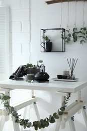 Stylish room decorated with beautiful green eucalyptus branches