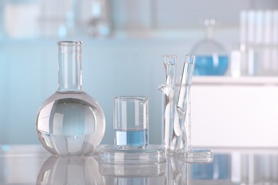 Laboratory analysis. Different glassware with liquid on white table indoors