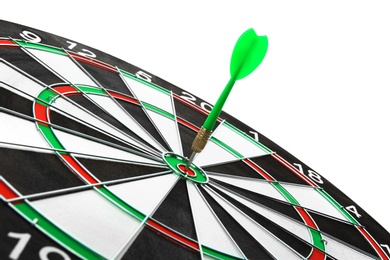 Photo of Dart board with color arrow hitting target, closeup