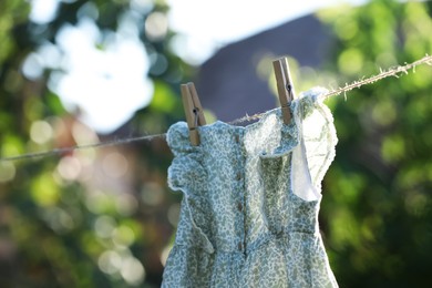 Dress drying on washing line against blurred background