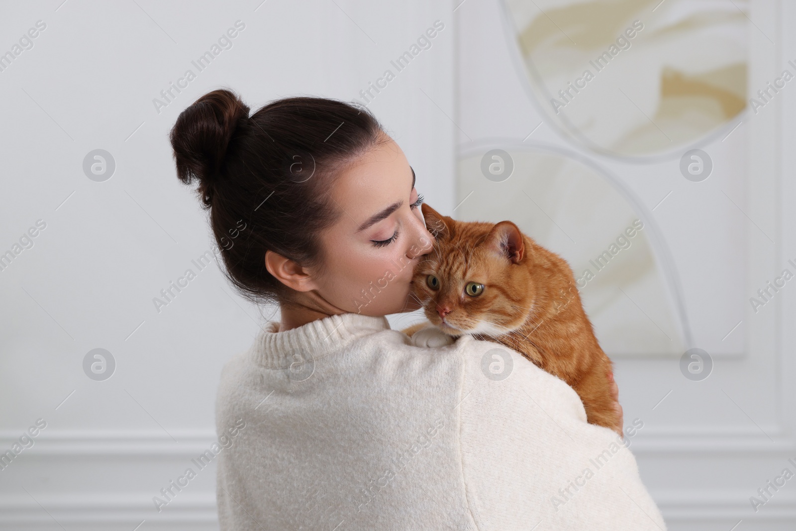 Photo of Beautiful woman with cute cat at home