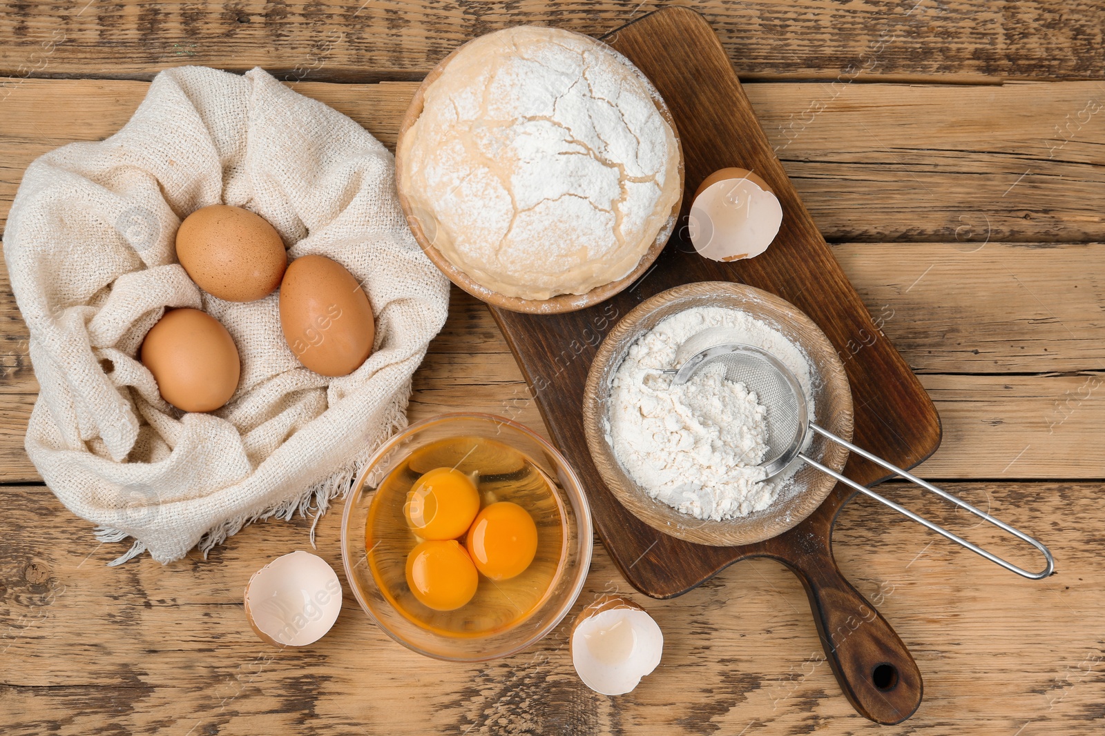 Photo of Flat lay composition with raw eggs and other ingredients on wooden table. Baking pie