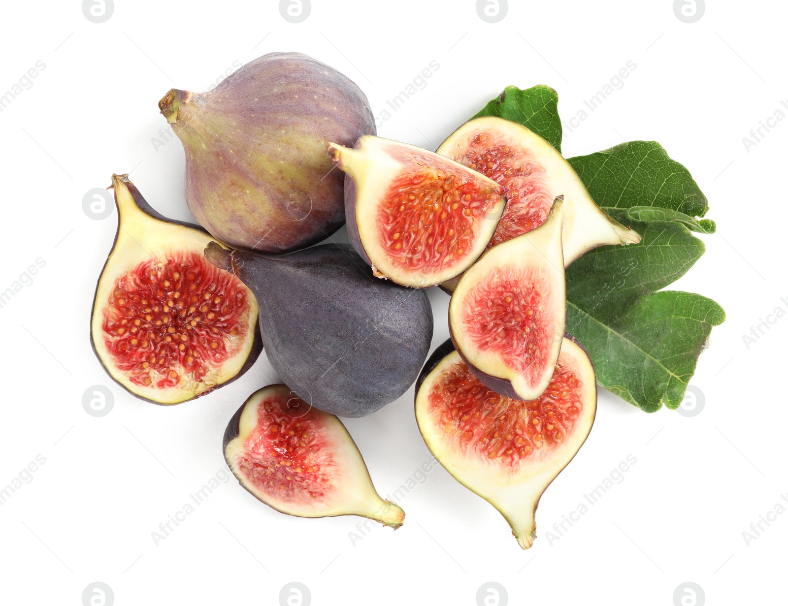 Photo of Whole and cut tasty fresh figs with green leaf on white background, top view