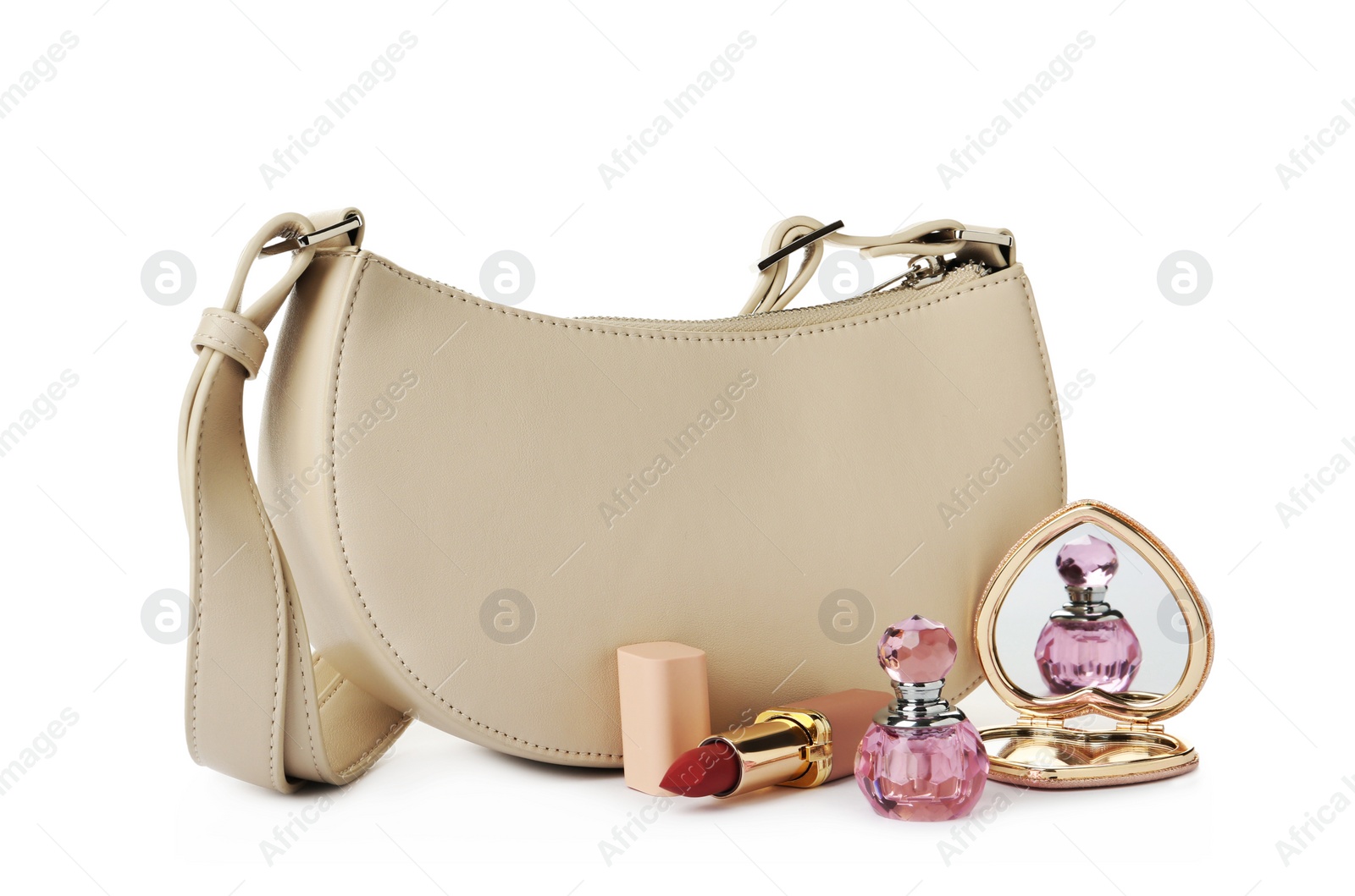 Photo of Stylish baguette bag with perfume, pocket mirror and lipstick on white background