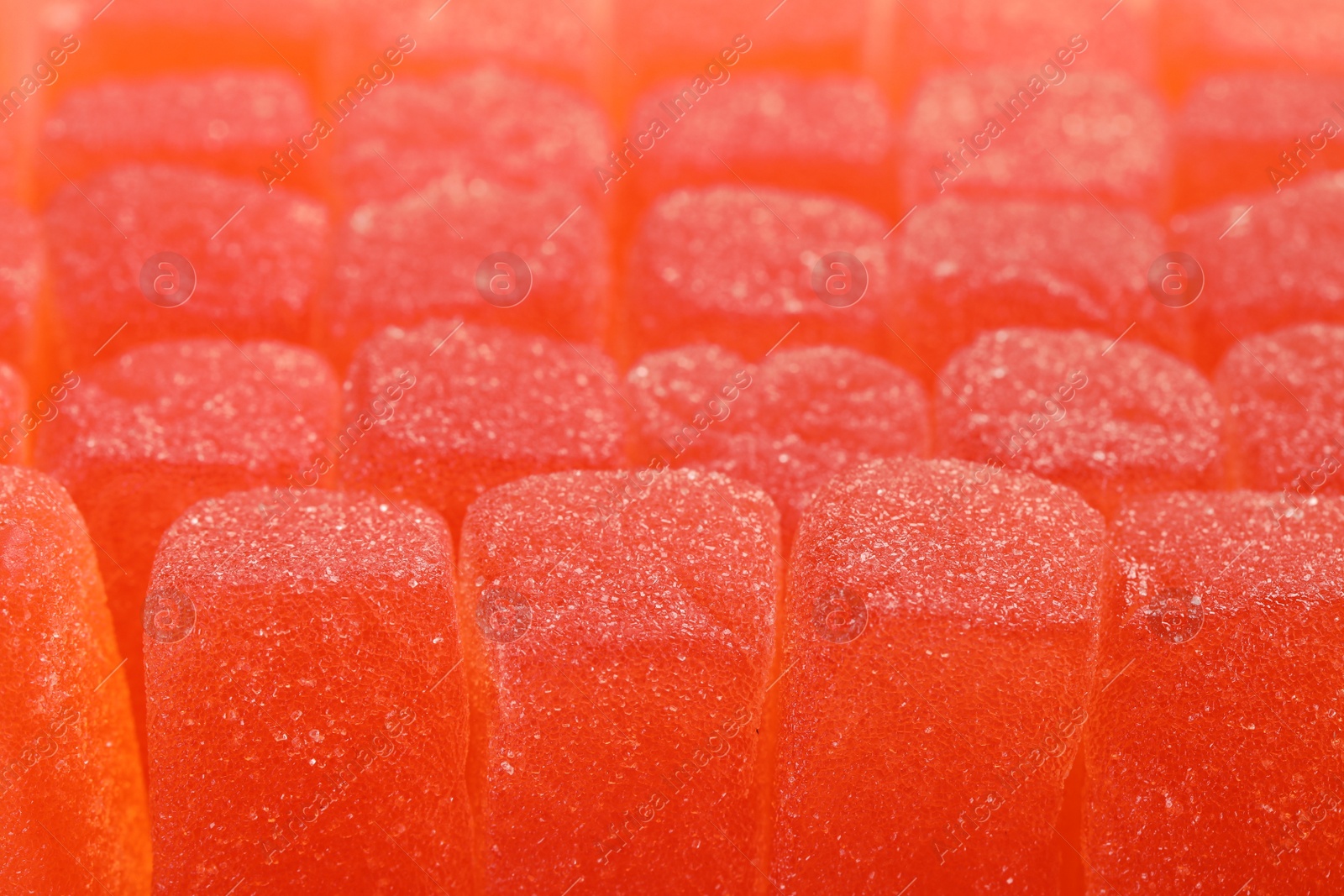 Photo of Tasty orange jelly candies as background, closeup