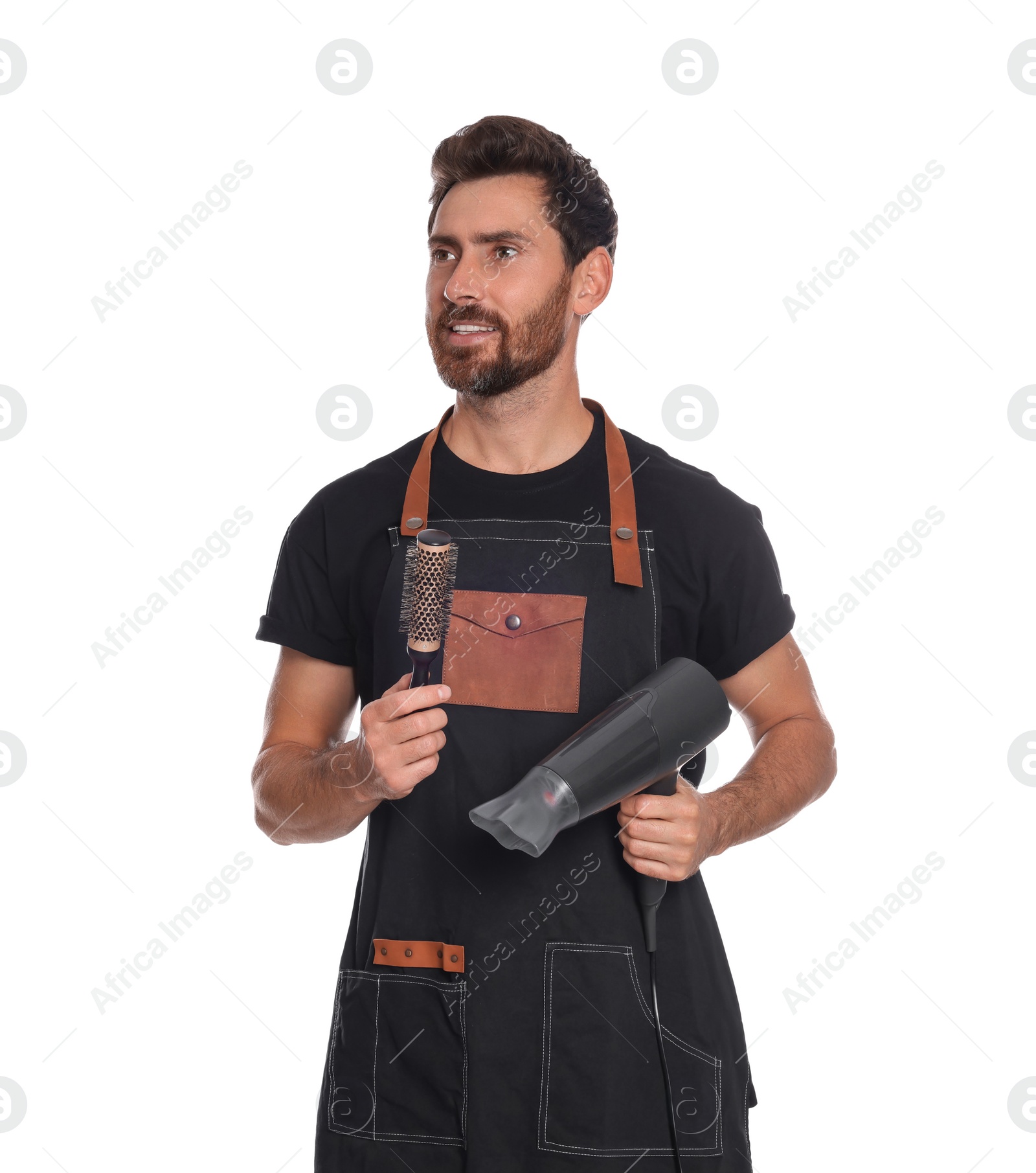 Photo of Professional hairdresser holding brush and dryer on white background