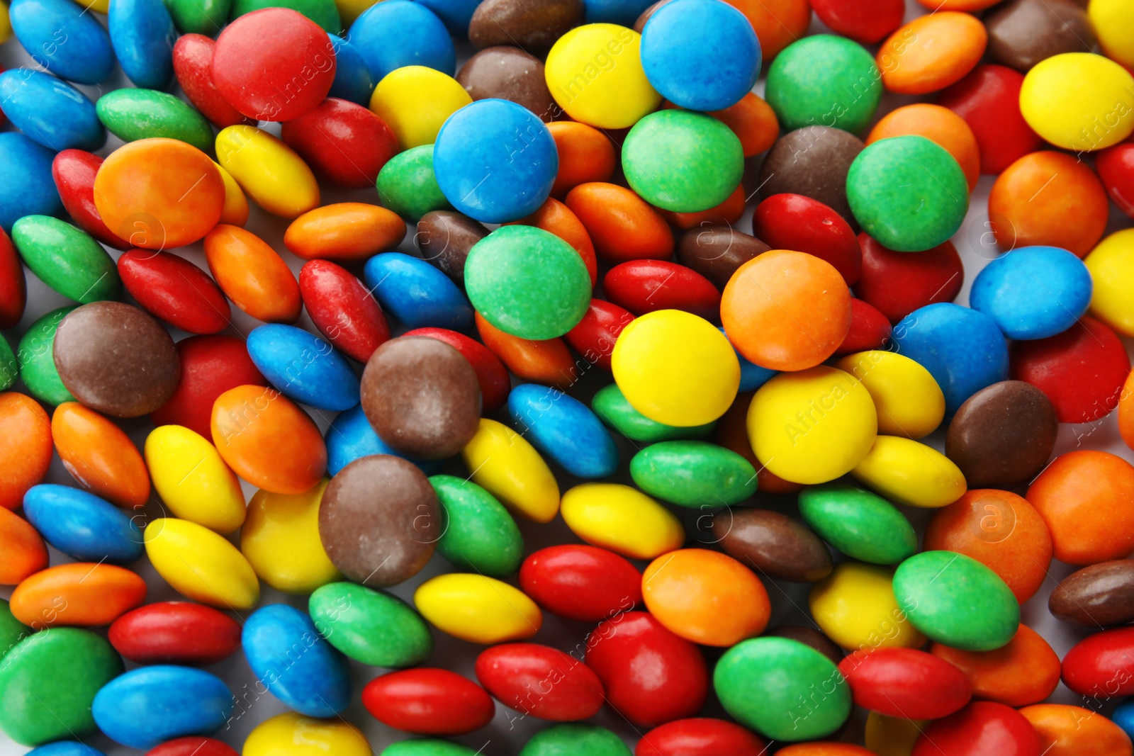 Photo of Many colorful candies as background, top view