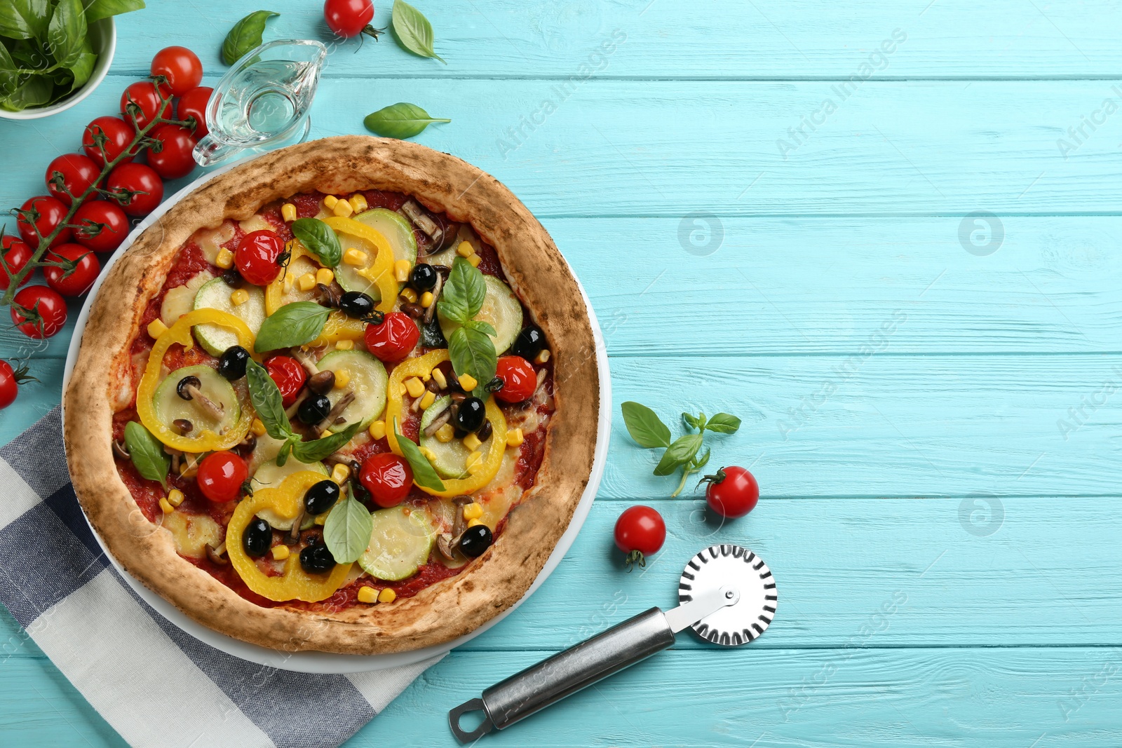 Photo of Flat lay composition with vegetable pizza on light blue wooden table. Space for text