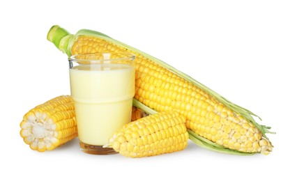 Photo of Tasty fresh corn milk in glass and cobs on white background