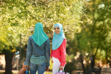 Photo of Muslim women walking in park on sunny day