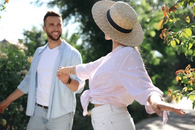 Photo of Lovely young couple dancing together in park on sunny day