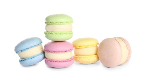 Many delicious colorful macarons on white background