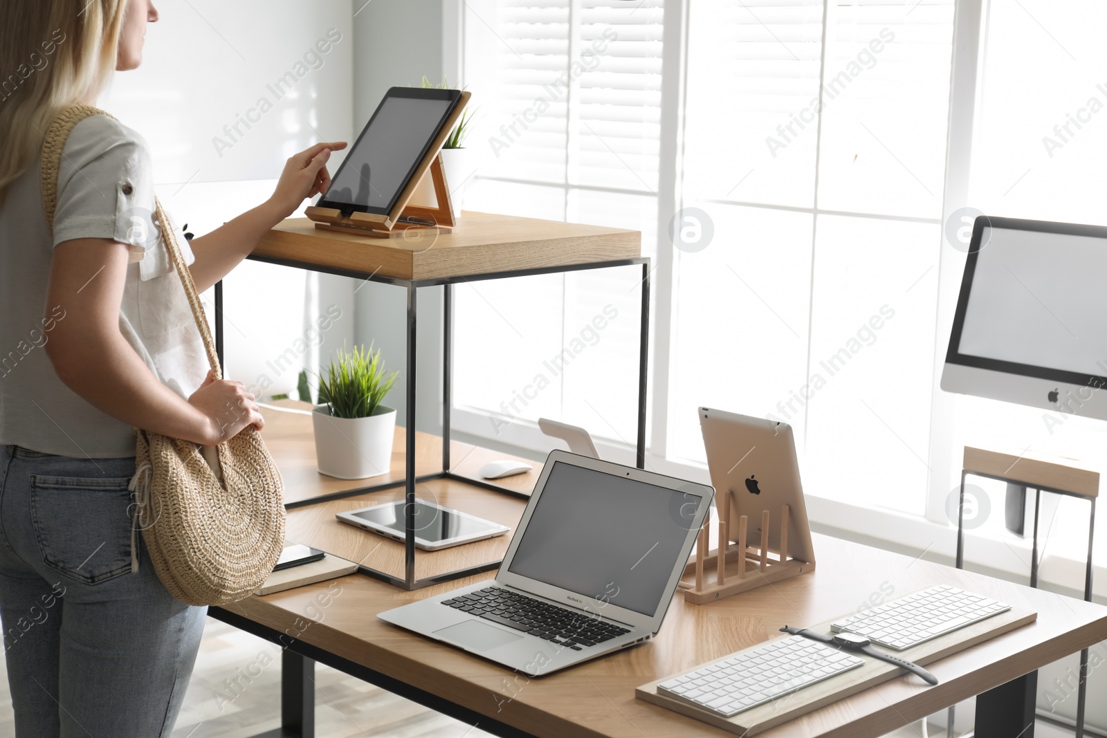 Photo of MYKOLAIV, UKRAINE - AUGUST 17, 2020: Woman choosing iPad in Apple store, closeup