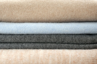 Photo of Stack of cashmere clothes as background, closeup